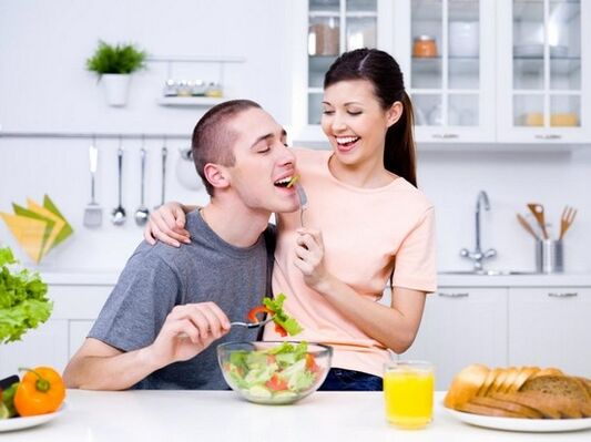 A girl feeds her man with products to increase potency